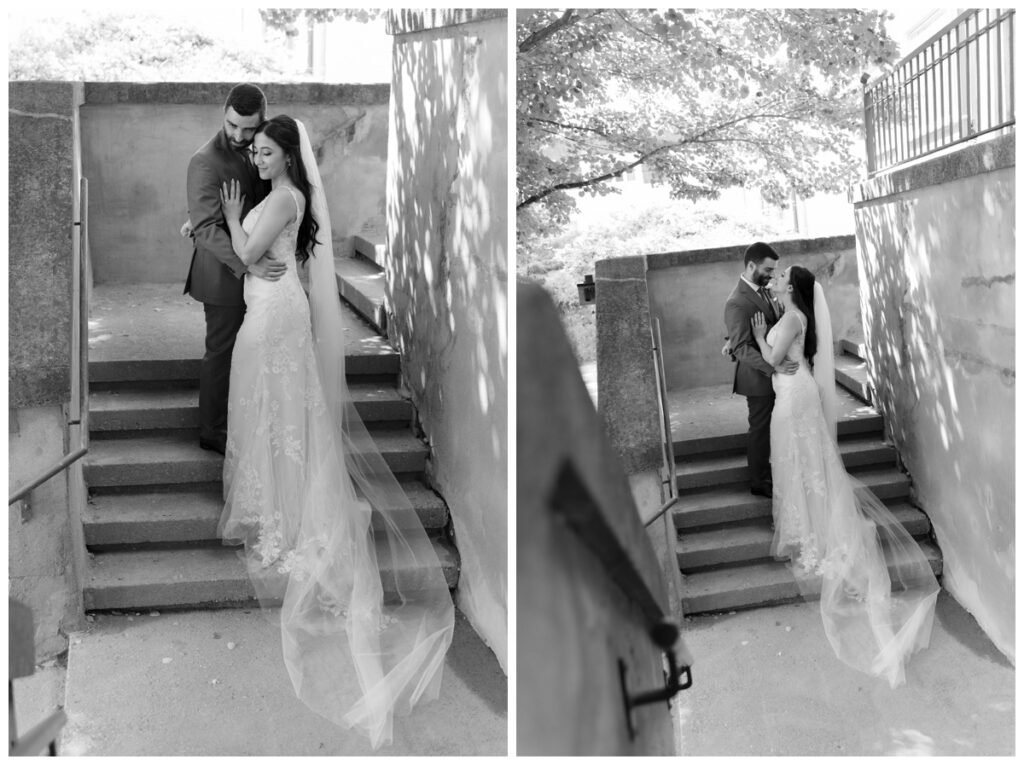 Black and white portrait of the bride and groom on a stone staircase